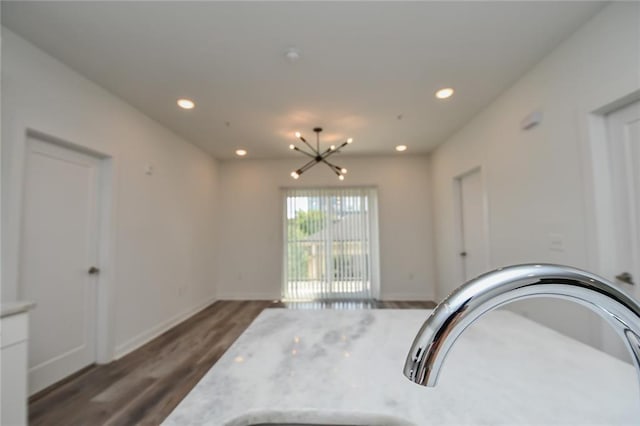 interior space featuring an inviting chandelier and dark hardwood / wood-style flooring