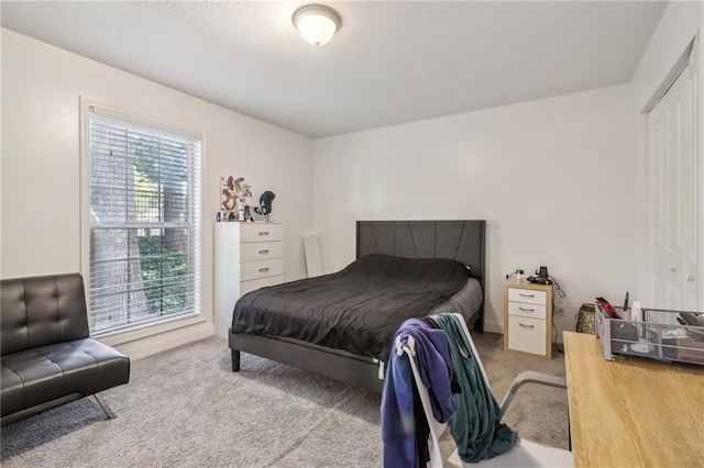 carpeted bedroom featuring multiple windows