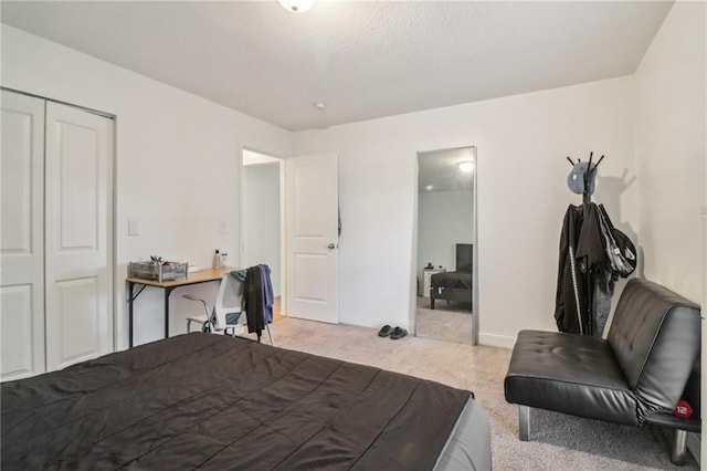 bedroom with a closet and light colored carpet