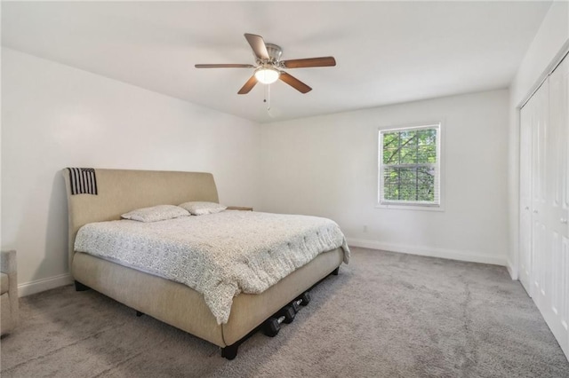 bedroom with a closet, light colored carpet, and ceiling fan