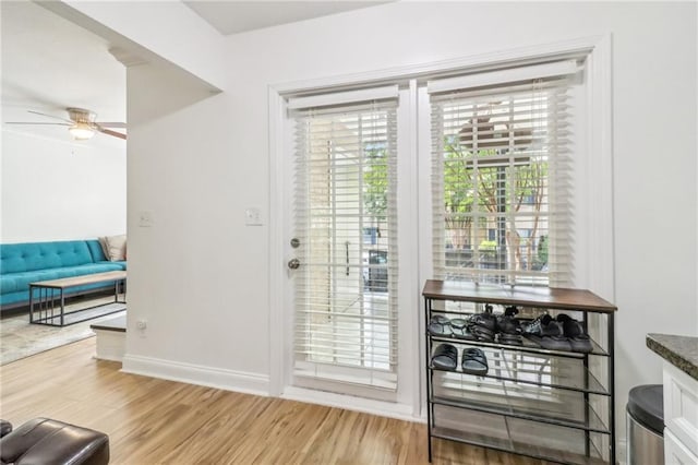 doorway to outside featuring hardwood / wood-style floors and ceiling fan