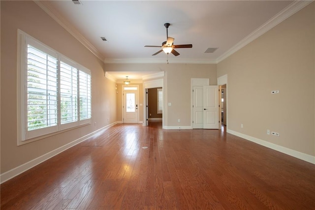 spare room featuring crown molding, ceiling fan, and dark wood-type flooring