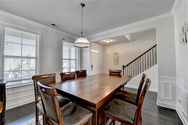dining room featuring dark wood finished floors, visible vents, and crown molding