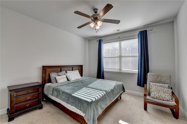 bedroom with light carpet, visible vents, and baseboards