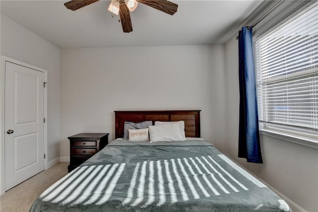bedroom with baseboards, a ceiling fan, and carpet