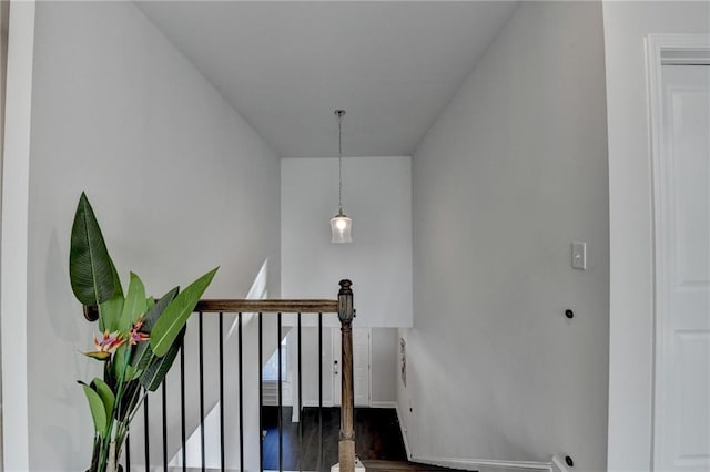 stairway with baseboards and wood finished floors