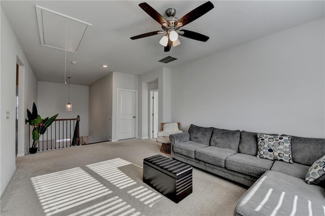 living room featuring visible vents, attic access, and carpet floors