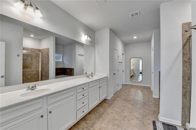 bathroom featuring a sink, visible vents, a stall shower, and double vanity