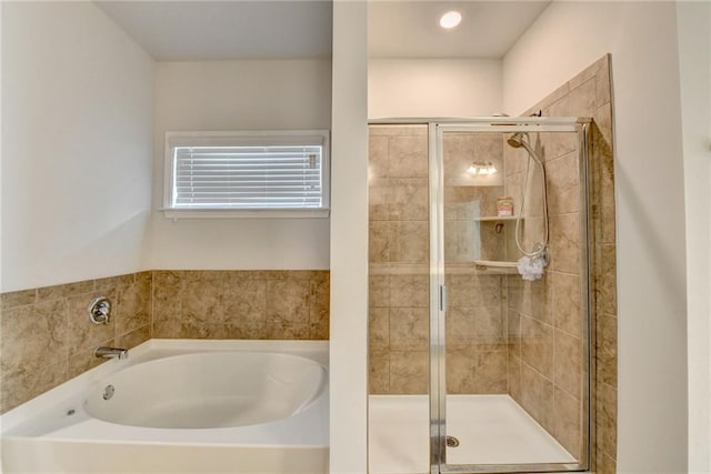 full bath featuring a garden tub and a stall shower