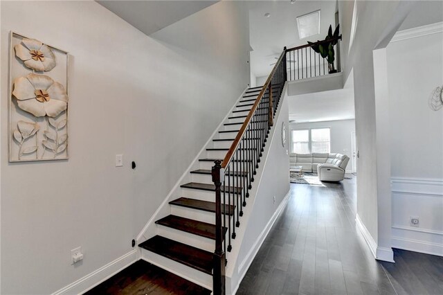 stairs with baseboards and wood finished floors