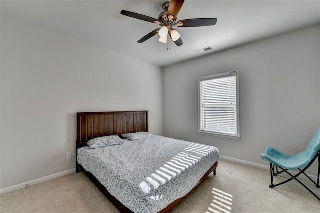 carpeted bedroom with a ceiling fan, baseboards, and visible vents