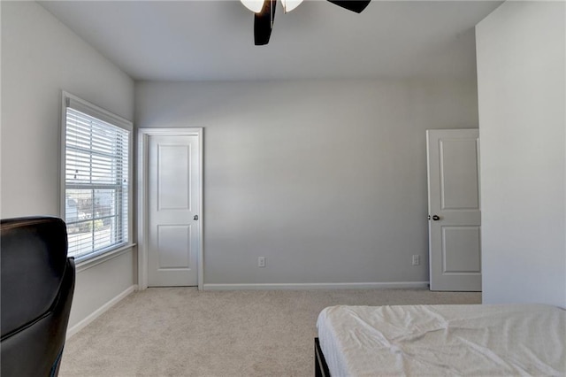 bedroom with a ceiling fan, baseboards, and carpet floors