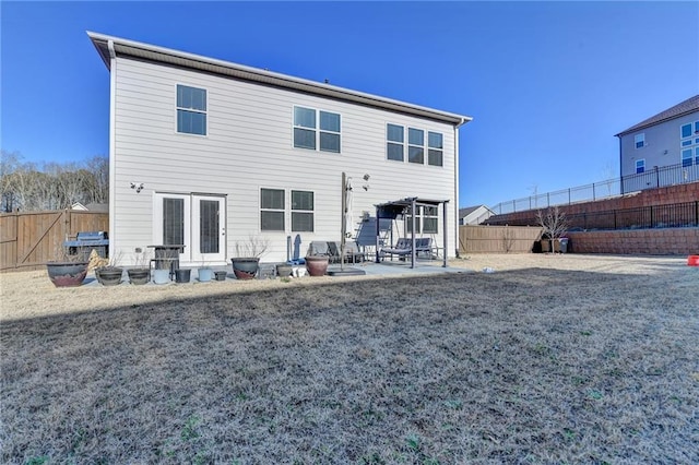 back of property featuring a patio and a fenced backyard
