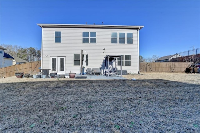 back of house featuring a patio and a fenced backyard