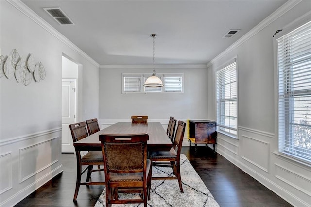 dining space with visible vents, dark wood-type flooring, and crown molding