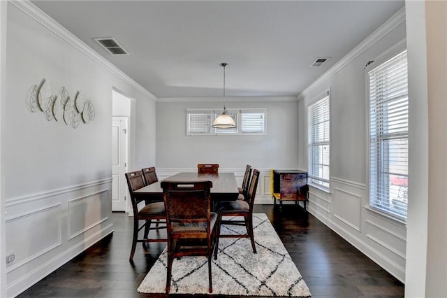 dining room with dark wood finished floors, crown molding, and visible vents