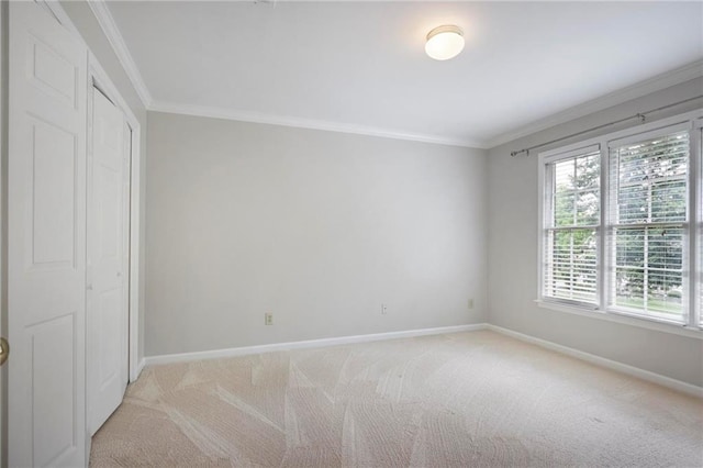 963 Bolingbrook Dr SW, Marietta, GA 30064 - unfurnished bedroom featuring baseboards, light colored carpet, ornamental molding, and a closet