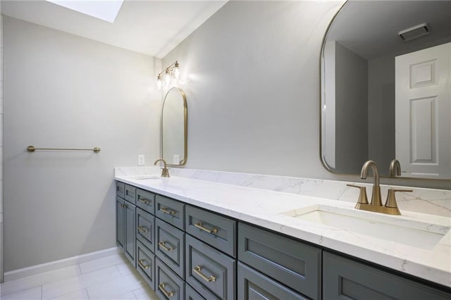 963 Bolingbrook Dr SW, Marietta, GA 30064 - bathroom featuring double vanity, baseboards, and a skylight