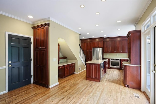 963 Bolingbrook Dr SW, Marietta, GA 30064 - kitchen featuring stainless steel appliances, dark brown cabinets, recessed lighting, light wood-style floors, and crown molding