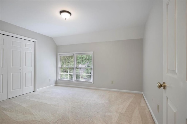 963 Bolingbrook Dr SW, Marietta, GA 30064 - unfurnished bedroom with vaulted ceiling, carpet flooring, baseboards, and a closet