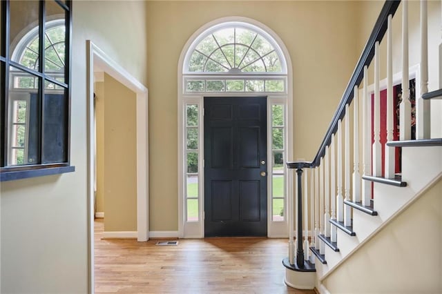 963 Bolingbrook Dr SW, Marietta, GA 30064 - entryway featuring wood finished floors, a high ceiling, stairs, and baseboards