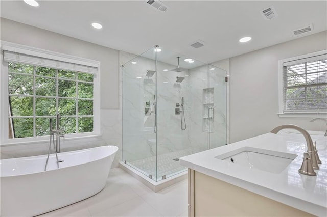 963 Bolingbrook Dr SW, Marietta, GA 30064 - bathroom with a marble finish shower, a soaking tub, vanity, tile patterned flooring, and recessed lighting