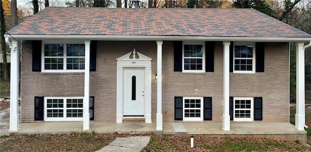 raised ranch featuring brick siding