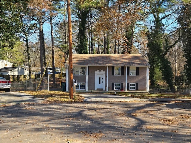 raised ranch with brick siding and fence