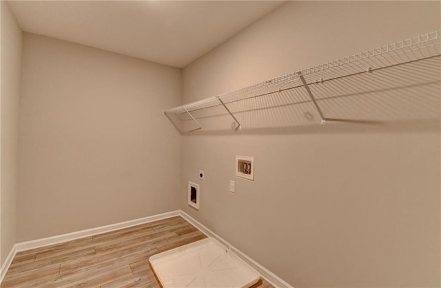 clothes washing area featuring hookup for a washing machine, hookup for an electric dryer, and hardwood / wood-style floors