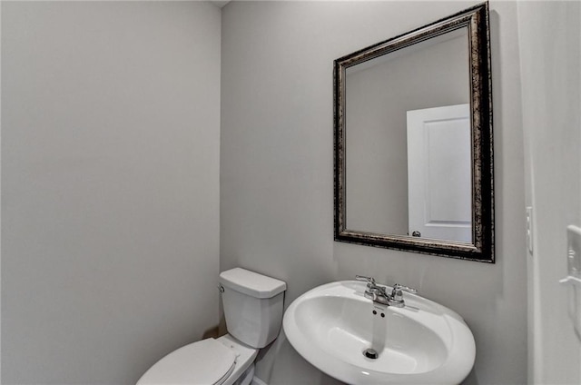 bathroom with toilet and sink