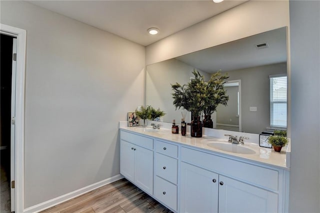 bathroom with hardwood / wood-style flooring and vanity