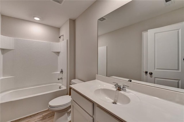 full bathroom featuring vanity, toilet, washtub / shower combination, and hardwood / wood-style flooring