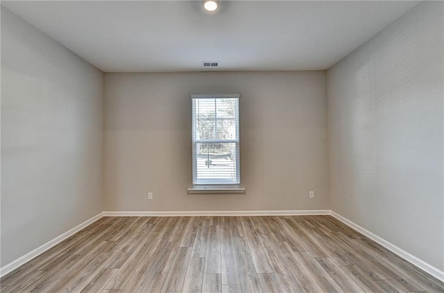 empty room with light hardwood / wood-style floors