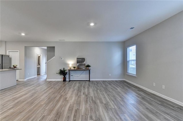 unfurnished living room with light hardwood / wood-style flooring