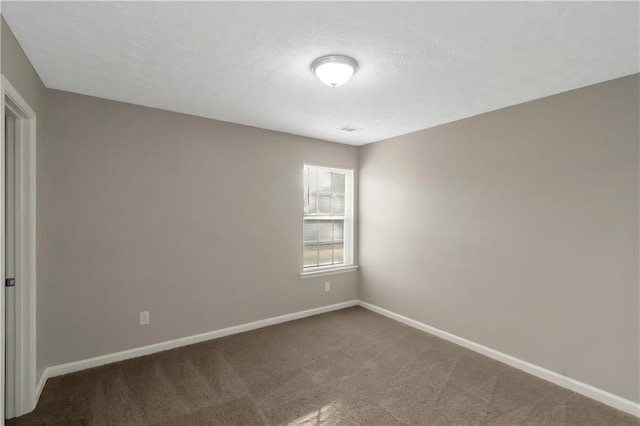 1011 Riverclift Dr, Covington, GA 30016 - empty room featuring baseboards, dark carpet, and a textured ceiling