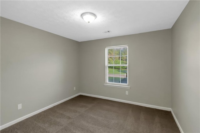 1011 Riverclift Dr, Covington, GA 30016 - unfurnished room featuring baseboards, dark colored carpet, and a textured ceiling