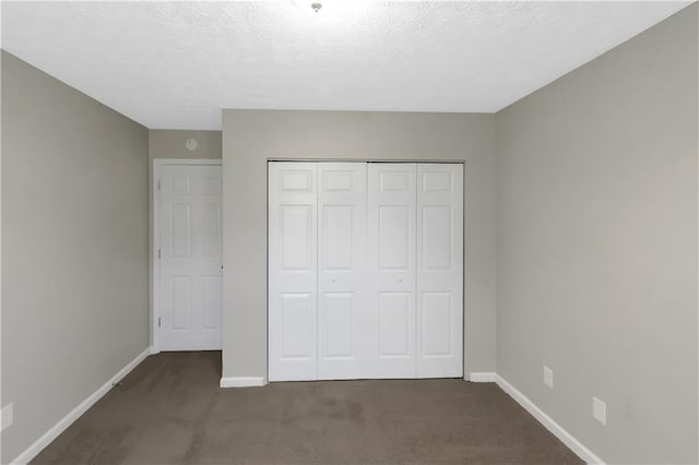 1011 Riverclift Dr, Covington, GA 30016 - unfurnished bedroom with baseboards, carpet floors, a closet, and a textured ceiling