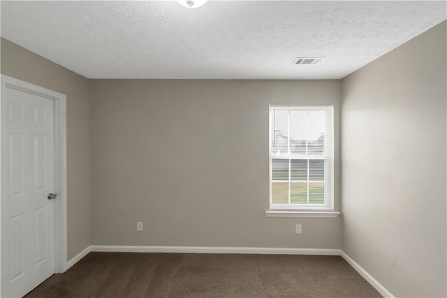1011 Riverclift Dr, Covington, GA 30016 - spare room featuring baseboards, dark colored carpet, and a textured ceiling