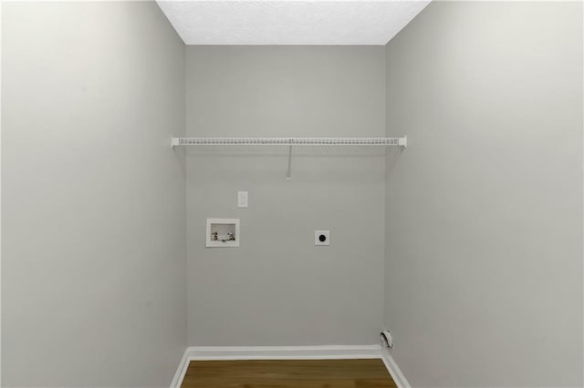 1011 Riverclift Dr, Covington, GA 30016 - laundry room with hookup for an electric dryer, washer hookup, wood finished floors, and baseboards