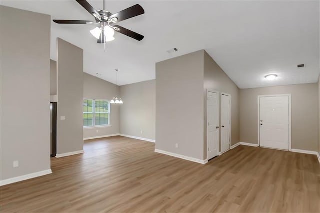 1011 Riverclift Dr, Covington, GA 30016 - unfurnished living room featuring a chandelier, light wood finished floors, a ceiling fan, baseboards, and high vaulted ceiling