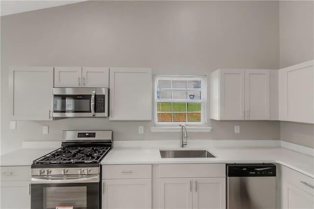 1011 Riverclift Dr, Covington, GA 30016 - kitchen with stainless steel appliances, a sink, light countertops, and white cabinets