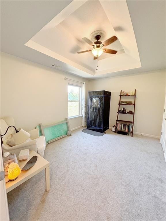 57 Matador, Newnan, GA 30263 - living area with a tray ceiling, carpet flooring, ceiling fan, and baseboards