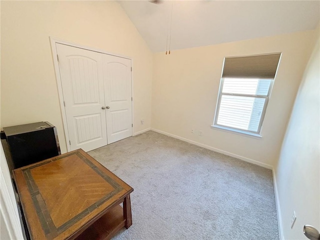 57 Matador, Newnan, GA 30263 - unfurnished bedroom with carpet flooring, vaulted ceiling, baseboards, and a closet