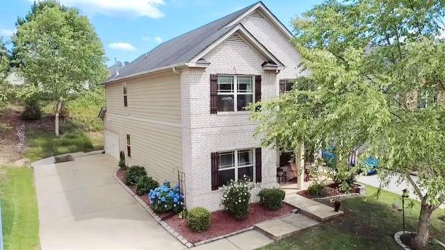 57 Matador, Newnan, GA 30263 - view of home's exterior featuring brick siding, driveway, and a garage