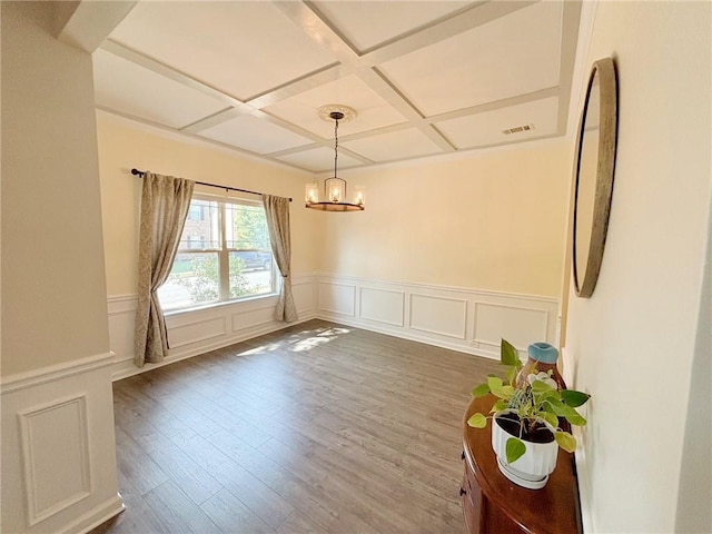 57 Matador, Newnan, GA 30263 - unfurnished dining area featuring coffered ceiling, a chandelier, wood finished floors, beam ceiling, and a wainscoted wall