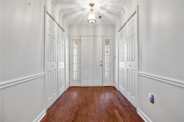 doorway featuring dark wood-type flooring and ornamental molding