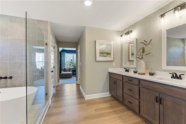 bathroom featuring independent shower and bath, vanity, and hardwood / wood-style floors