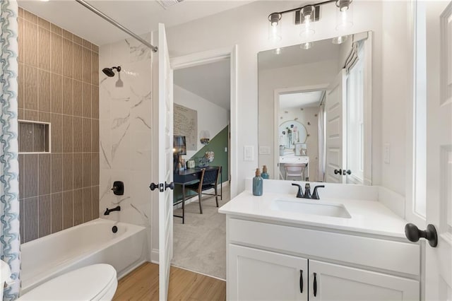 full bathroom with vanity, hardwood / wood-style floors, toilet, and shower / bath combo