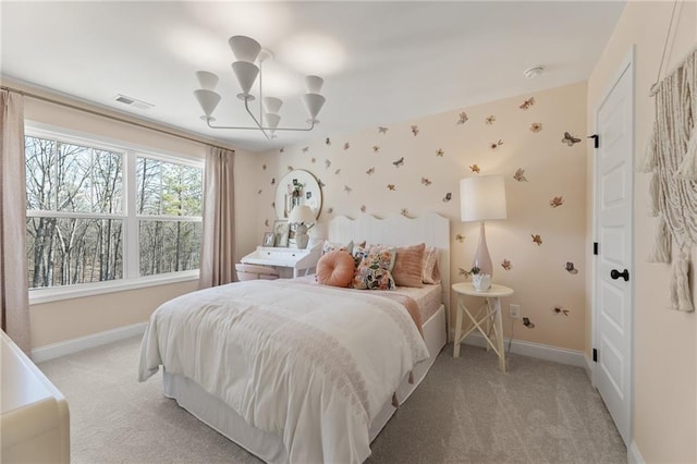 carpeted bedroom featuring an inviting chandelier