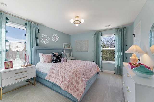 bedroom featuring light colored carpet